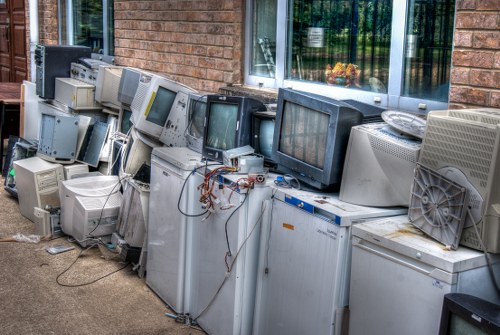 Eco-friendly loft clearance process in Highbury with recycling bins